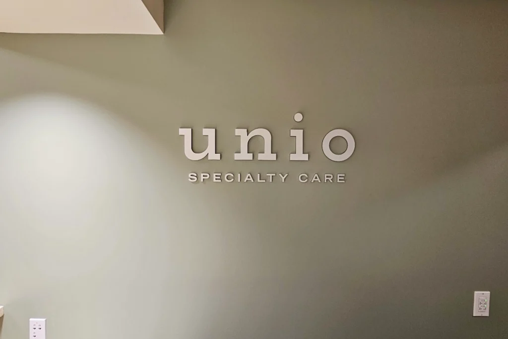 Full view of Downey clinic lobby signage installation at Unio Healthcare