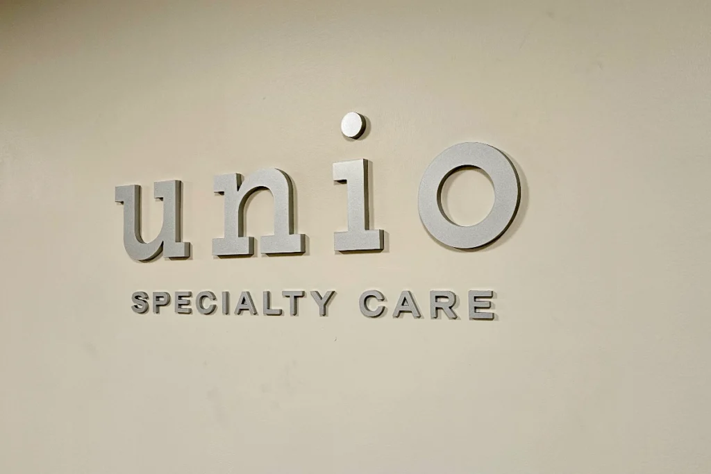 Healthcare office signage at Unio Healthcare Downey with metallic silver acrylic letters