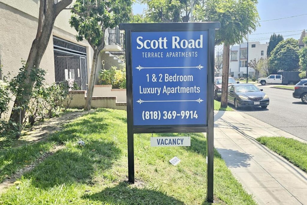 Exterior post and panel building signage at Scott Road Terrace Apartments in Burbank