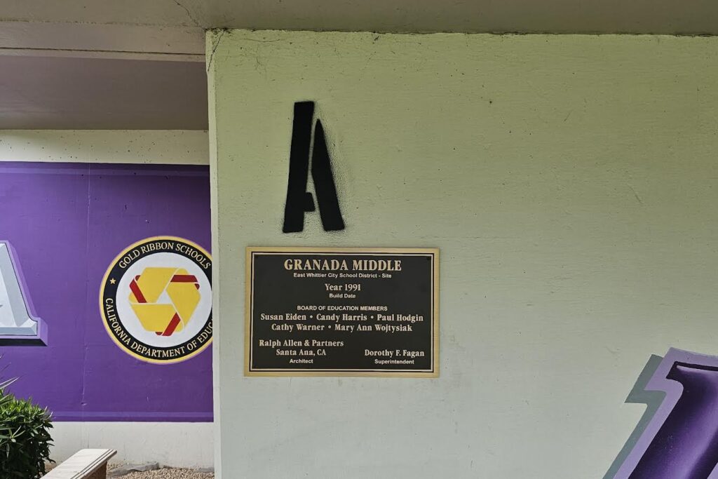 Bronze plaque set for dedication near school building entrance