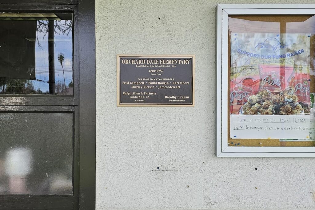 Exterior school plaque installed under campus welcome signage