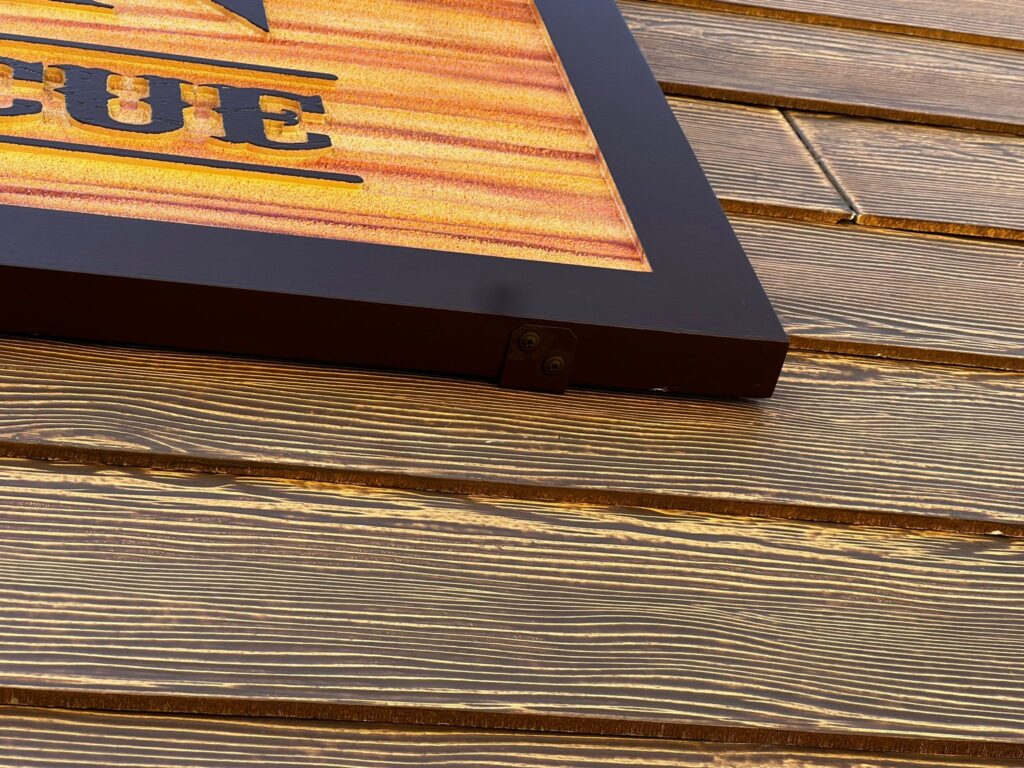 Close-up of woodgrain finish showcasing natural texture and depth in signage design