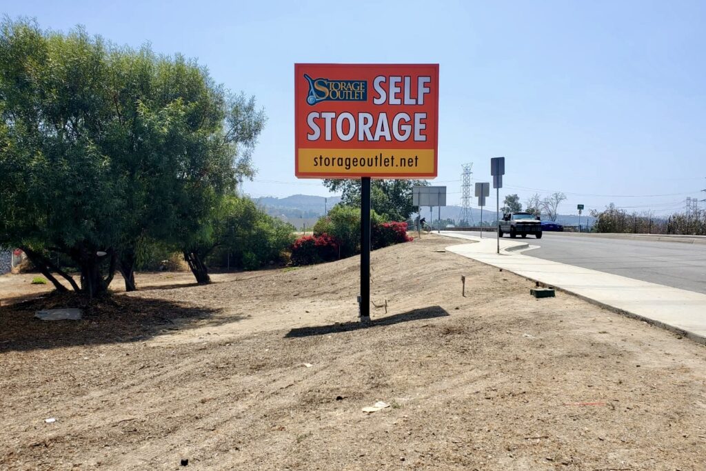 Double-sided LED pole sign for Storage Outlet in El Monte at night