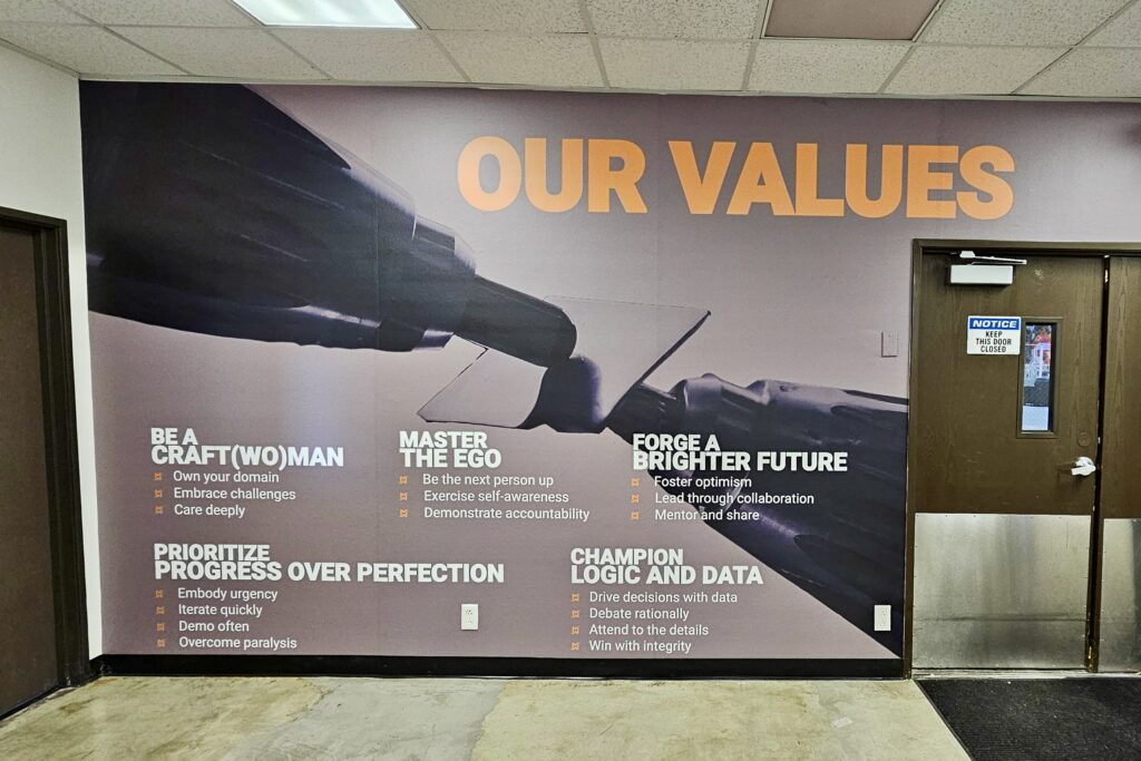 Large-format UV printed wall mural branding Machina Labs’ modern tech workspace in LA