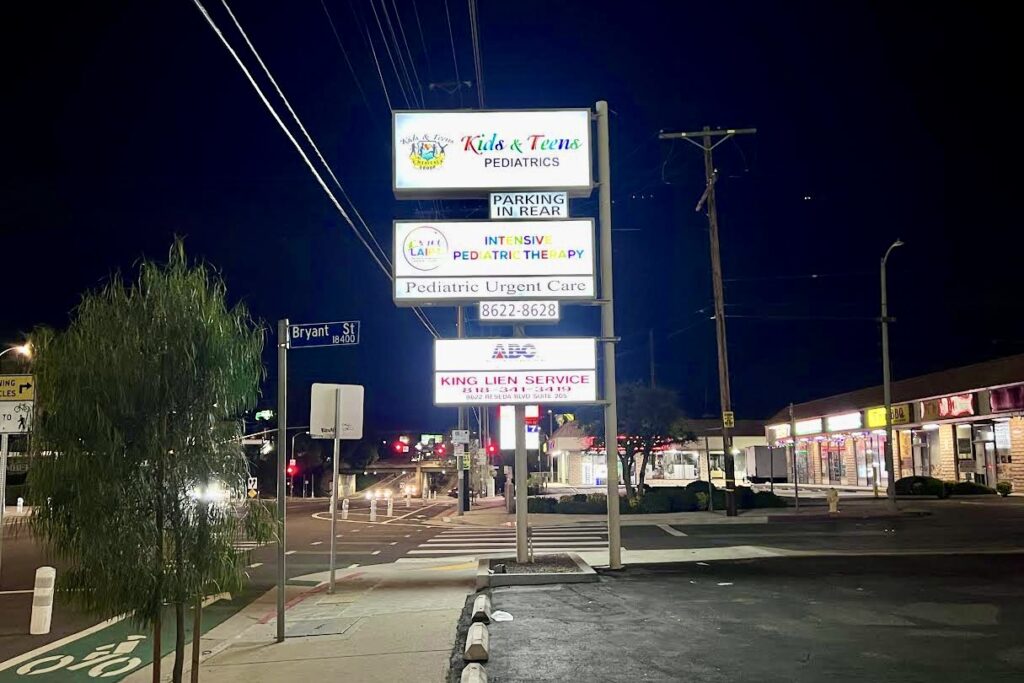 Commercial lightbox pole sign for pediatric medical center on Northridge busy corridor.