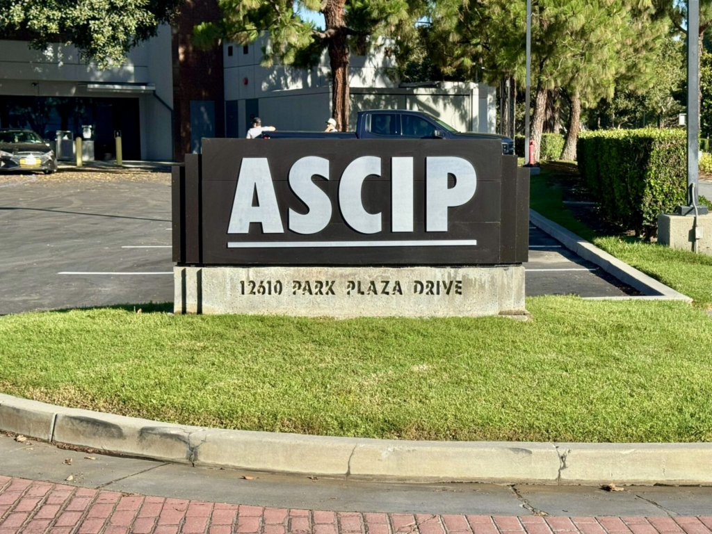 ASCIP monument sign with address on landscaped entrance lawn.